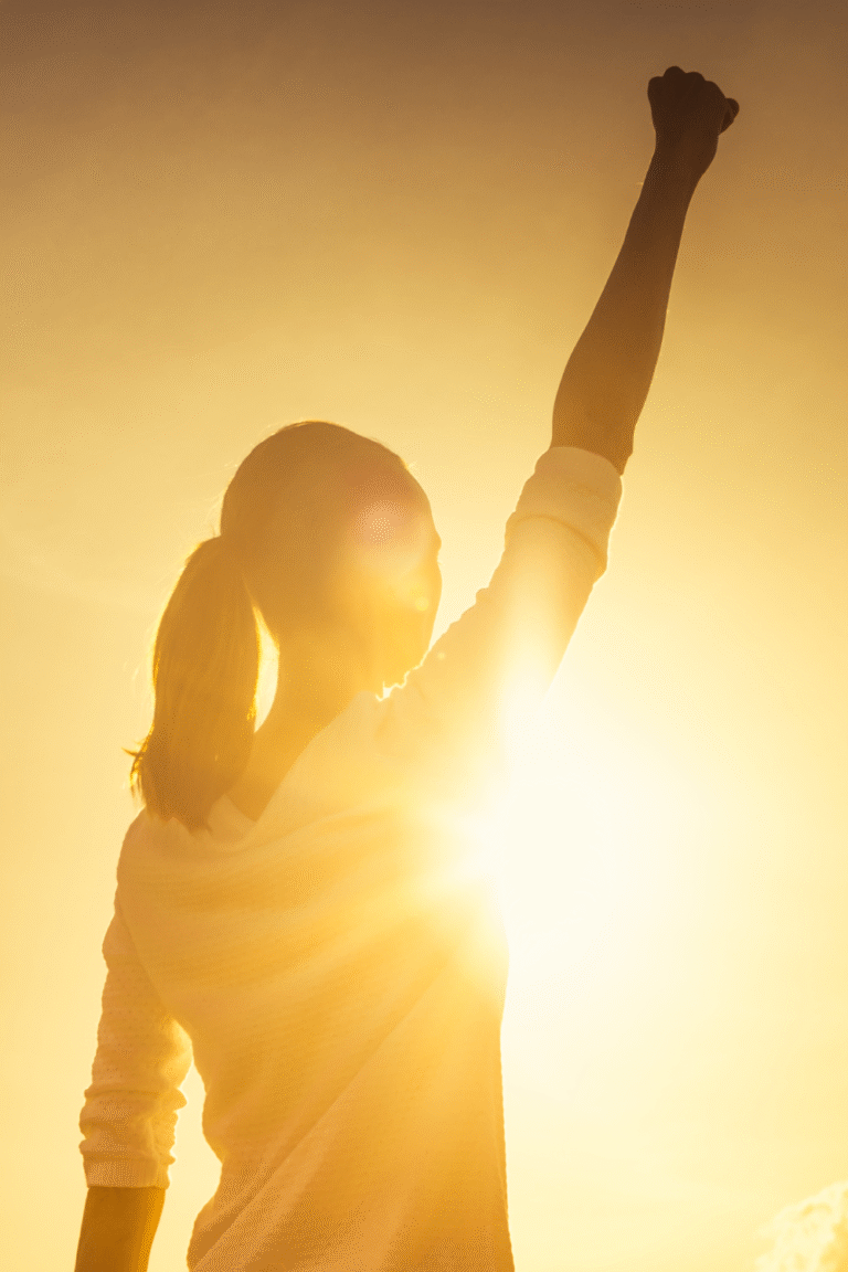 Woman taking a confident step forward, reflecting the courage to move before feeling ready